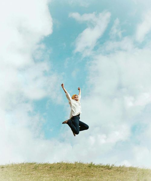 Person stretching outdoors, radiating positive energy and vitality.